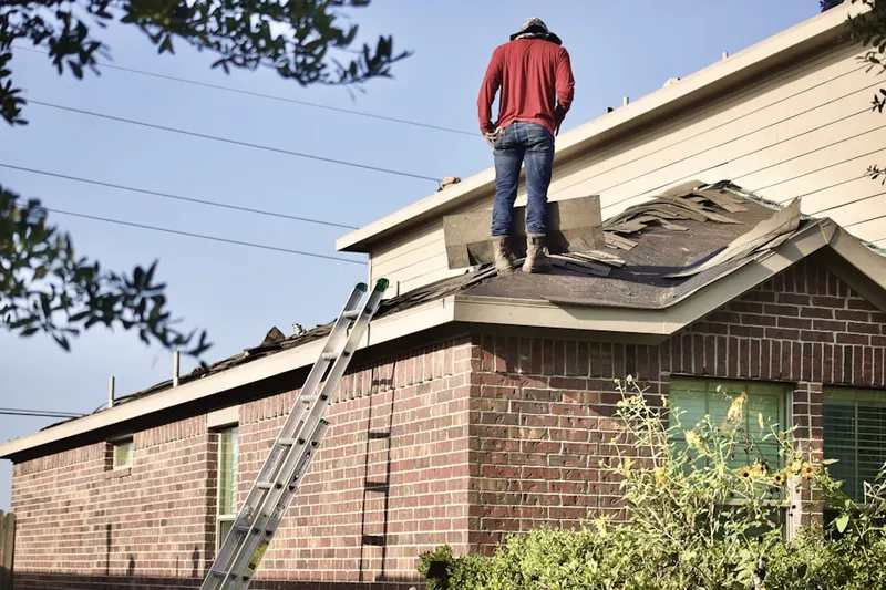 Professional roofer working on a residential roof in East Millersport